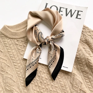 Champagne silk square scarf with houndstooth and chain patterns on knit sweater