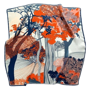 Silk square scarf featuring vibrant forest print in orange and navy blue colors