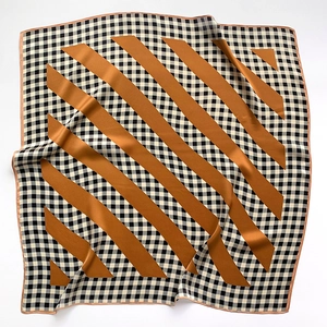 Detail of silk scarf with houndstooth pattern and orange diagonal stripes with satin sheen