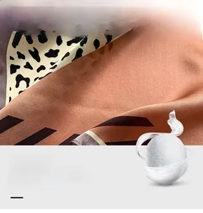 Detail of 100% mulberry silk scarf with leopard print and smooth glossy texture