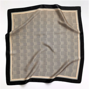 Detail of elegant houndstooth silk scarf with wide black border and satin texture