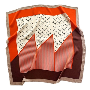 Silk-textured square scarf with crescent moon patterns and geometric orange color blocking