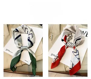 Close-up of elegant silk scarves in green and red stripes with pearl accessories