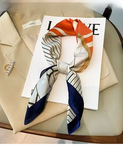 Detail of silk-like neckerchief with geometric pattern on elegant beige blazer