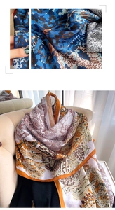 Détail montrant la texture soyeuse et les imprimés floraux élégants du foulard d'été