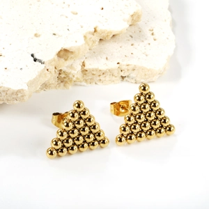 Golden geometric triangle stud earrings made of small polished steel beads on stone background