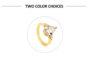 Detail of 18k gold ring featuring a pear-shaped cubic zirconia and three-stone prong setting