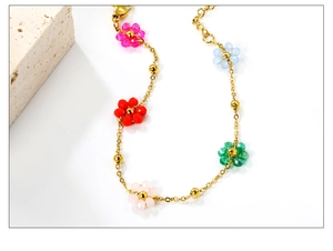 Detail of 18k gold-plated bracelet with colorful crystal flowers and lobster clasp