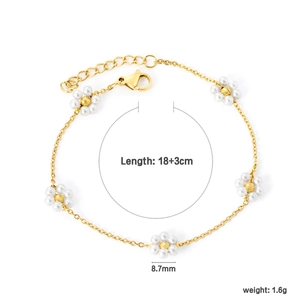 Detailed view of gold stainless steel bracelet with white pearl daisy flowers and lobster clasp