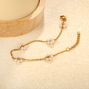 Detail of gold chain bracelet with five pearl flowers and adjustable lobster clasp closure