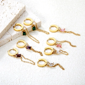 Detail of 18K gold-plated earrings with emerald, pink, purple and clear zircon charms