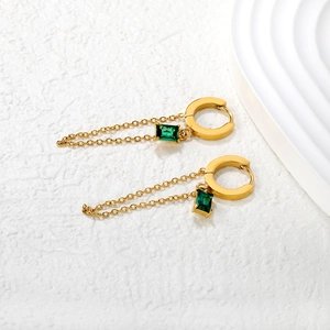 Detail of 18K gold plated stainless steel tassel earrings with green zircon stones