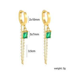 Golden geometric tassel earrings with green zircon and steel chains on white background