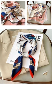 Close-up of vintage carriage print silk scarf with golden chains and tassel details