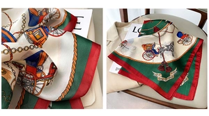 Close-up of vintage carriage and chain print silk scarf with classic red and green colors