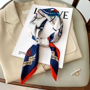 Silk square scarf with vintage chain and horse patterns paired with a beige suit