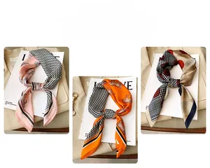 Detailed view of three silk scarves with houndstooth and horse patterns on a blazer