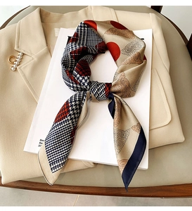 Detail of silk-feel scarf with houndstooth and polka dot prints on a blazer