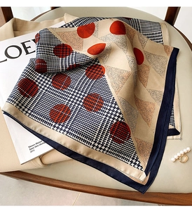 Detail of silk-satin scarf featuring paisley and houndstooth prints on elegant fabric