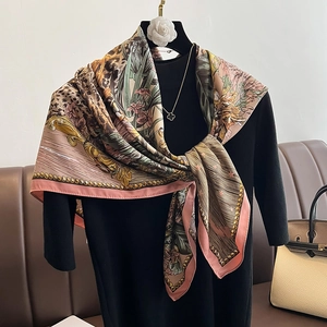 Detail of elegant floral and leopard print scarf draped over a black turtleneck top