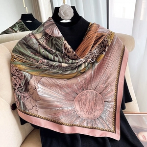 Detail of silk satin scarf featuring tropical palm leaf and leopard print patterns