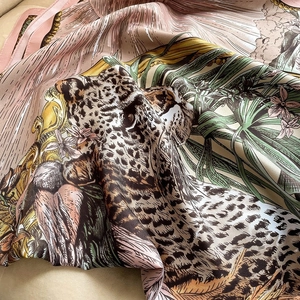 Artistic silk scarf with leopard and tropical plant print in soft pink and green