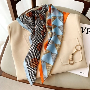 Silk-like fashion neckerchief with patchwork paisley and houndstooth print on a beige blazer