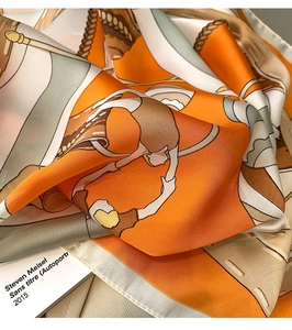 Close-up of silk scarf featuring nautical prints and orange satin sheen for handbags