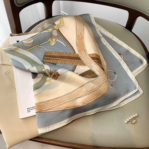 Elegant silk-like square scarf with classical print styled on a yellow blazer and magazine