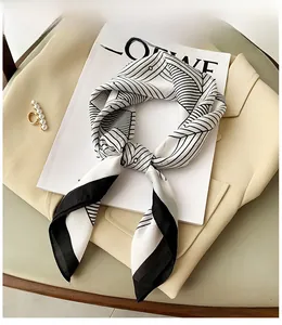 Detail of silk square scarf with geometric stripes on suit and magazine backdrop