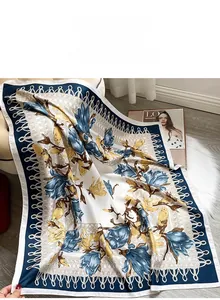 Detailed view of the elegant floral print scarf with intricate blue border and tassels