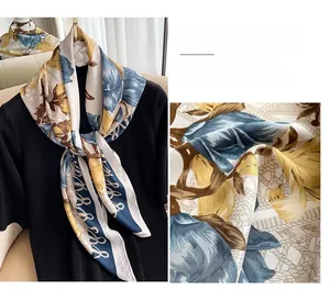 Detailed view of retro floral silk scarf with elegant chain pattern in gold and blue