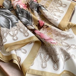 Detail of floral silk scarf showing elegant twill weave texture and artistic rose print