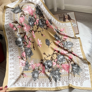 Detail view of large floral silk scarf with champagne gold border and soft texture