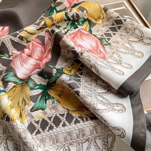 Detailed view of floral silk scarf featuring vintage rose patterns and smooth texture