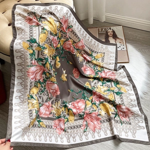 Detailed view of floral silk-feel square scarf with artistic print and knot pattern