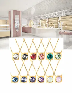 Detail view of square crystal pendant necklaces in twelve vibrant colors with gold plating