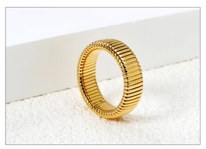 Macro shot of gold stainless steel ring featuring a unique ribbed linear texture design