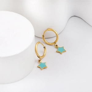 Close-up of golden hoop earrings with blue star-shaped pendants on a white display