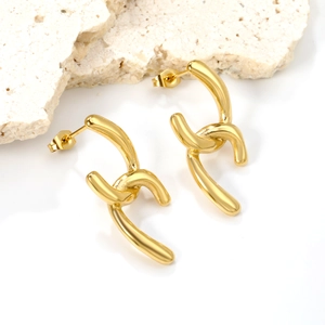 Abstract irregular golden stud earrings with polished twisted design on white stone base