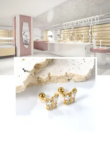 Detail showing butterfly zircon earrings with gold plating and secure screw ball backs