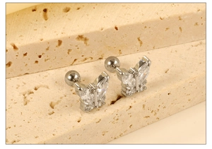 Macro shot of silver butterfly stud earrings with sparkling cubic zirconia and screw backs