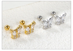 Detailed macro view of butterfly stud earrings with sparkling crystals and screw ball backs