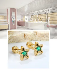 Detail of star-shaped gold-plated stud earring with central green zircon gemstone inlay