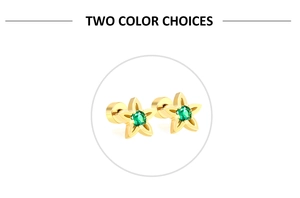 Close-up of gold star earrings with green emerald zircon center and screw-back detail