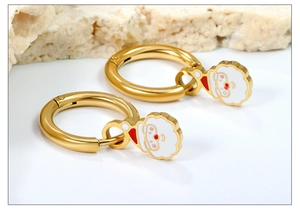 Detail of gold Santa Claus hoop earrings with red and white enamel finish on stone base