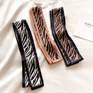 Detailed flat lay of three animal print twilly scarves with zebra and leopard patterns