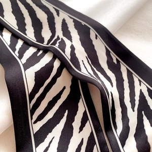 Macro shot of stylish black and white zebra pattern silk scarf with elegant stripes