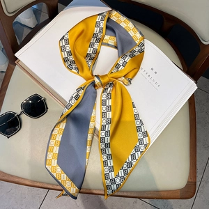 Silk-like fashion scarf with letter print and mustard yellow geometric color blocks