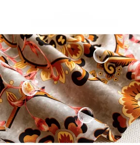 Detail of soft silk scarf fabric with retro floral print and smooth shiny texture